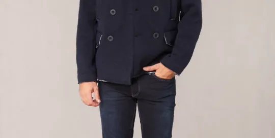 Men's navy wool double-breasted peacoat with cream shearling collar on model - Style #2111