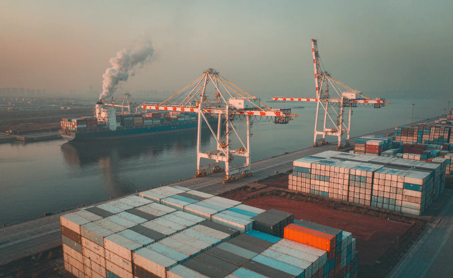 Container port at dawn — global outerwear sourcing and logistics