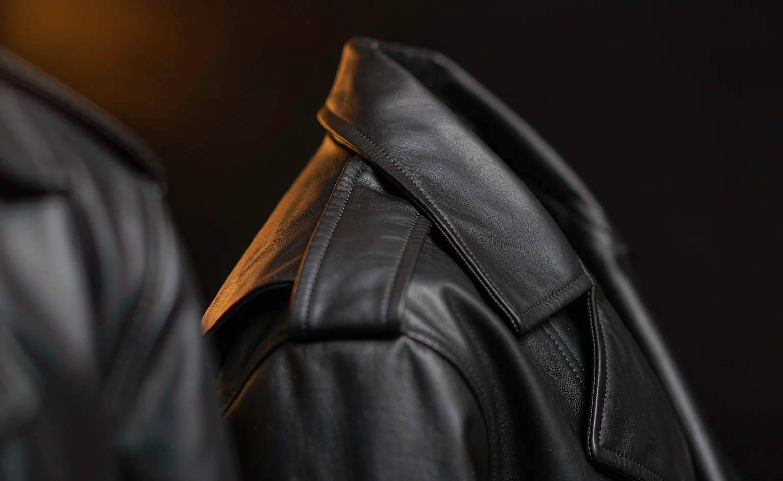Matte black PU leather jacket shoulder with clean stitching